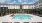 Resort-style swimming pool with lounge seating