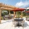 outdoor seating and grilling area with red umbrellas