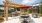 outdoor seating and grilling area with red umbrellas
