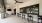 Outdoor lounge space with barstools and a tv