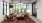 Well-lit lounge with a leather sofa and tall windows