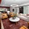 a large room with a red rug